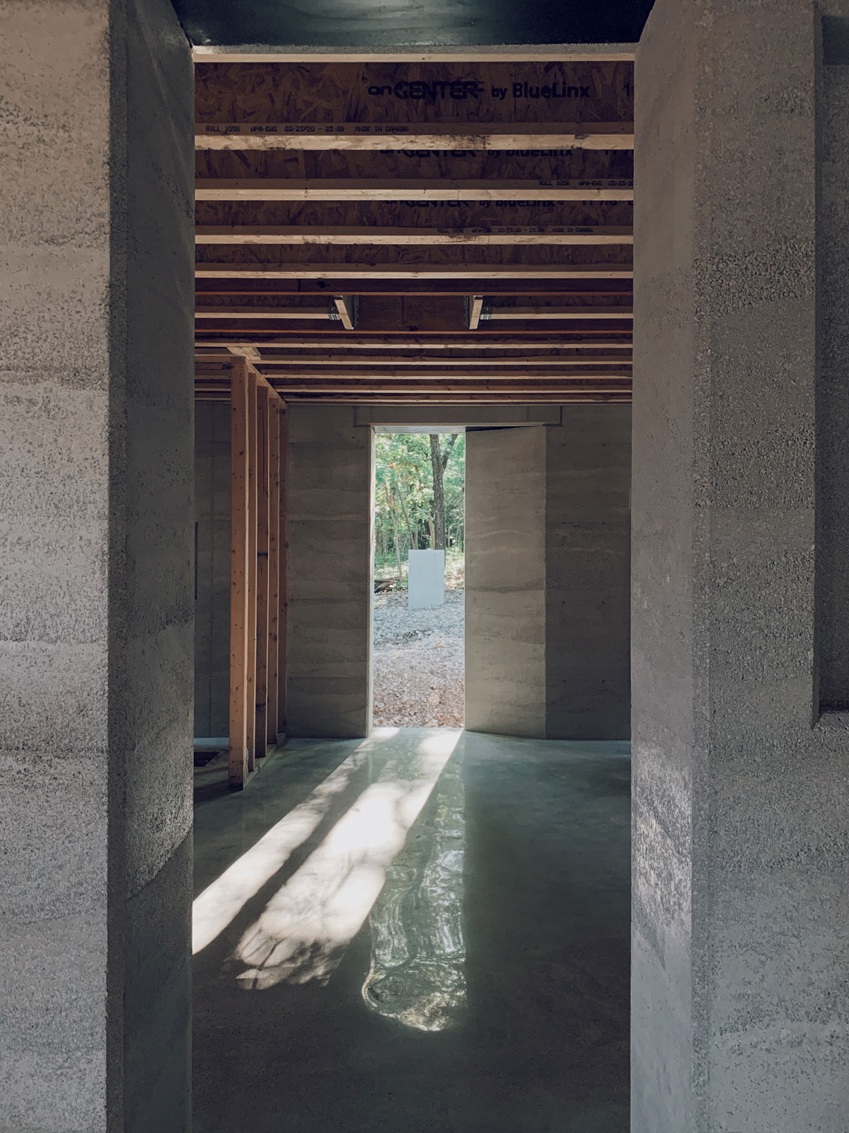 a peak into the master bedroom at the rammedearth modern cabin in Eureka Springs, AR