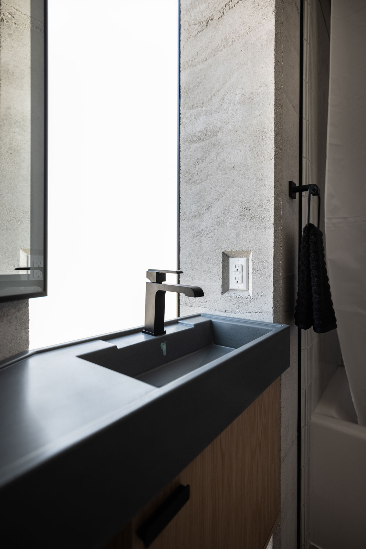 Frosted glass runs behind this sink, allowing light to spill out from underneath 