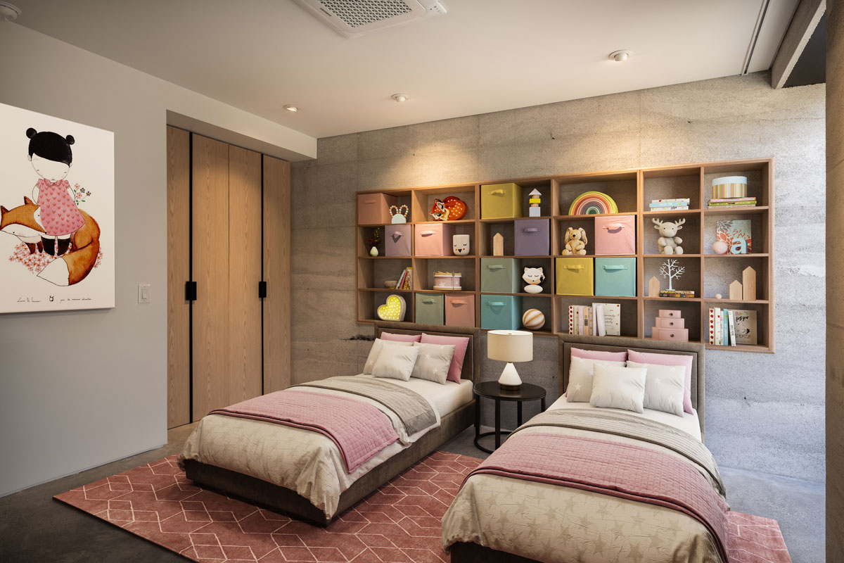 A modern kids room for two girls features a recessed oak bookcase in the rammed earth wall