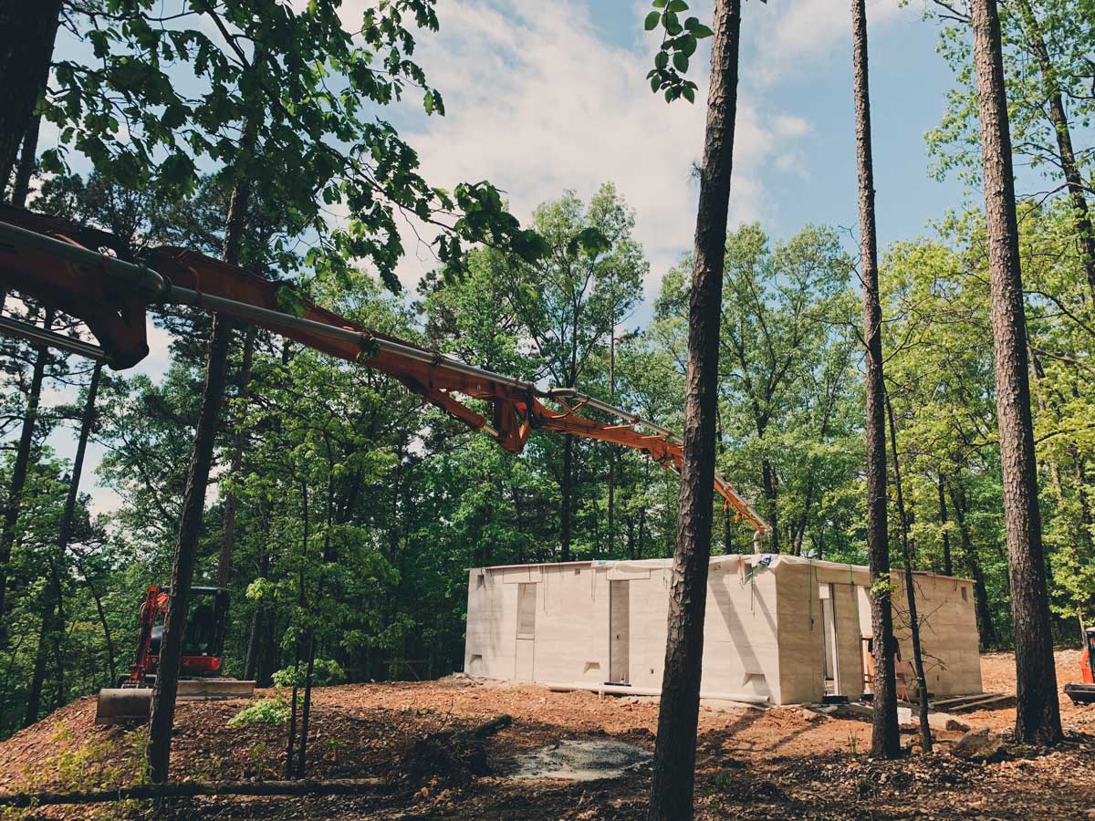 Pouring a concrete floor in a rammed earth house