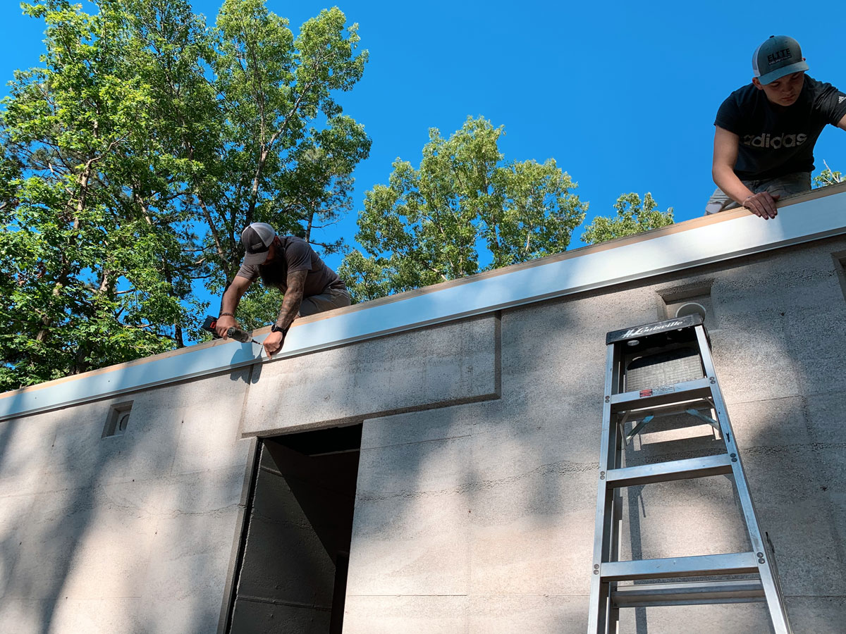 installing the custom metal fascia on the modern cabin in eureka springs, ar