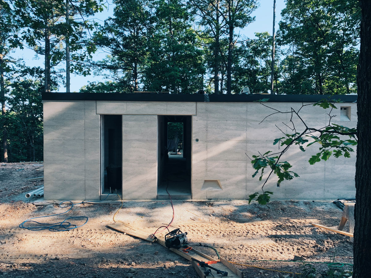 custom metal fascia installed on the rammed earth cabin