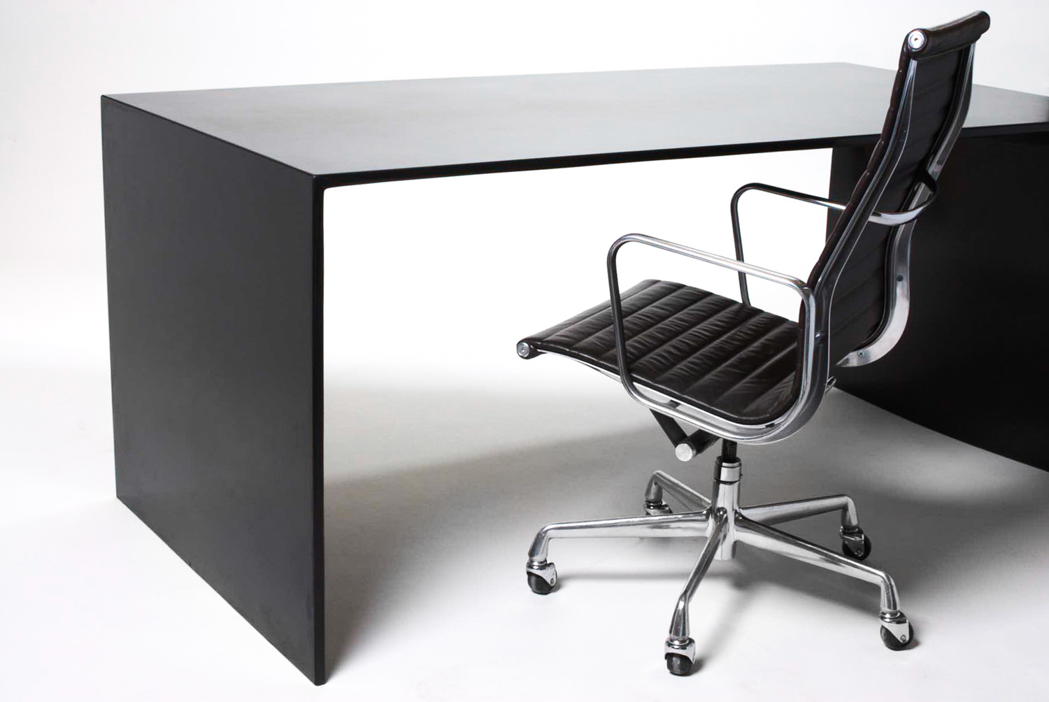 A custom black concrete desk for a modern home designed by Hufft Architects in Kansas City