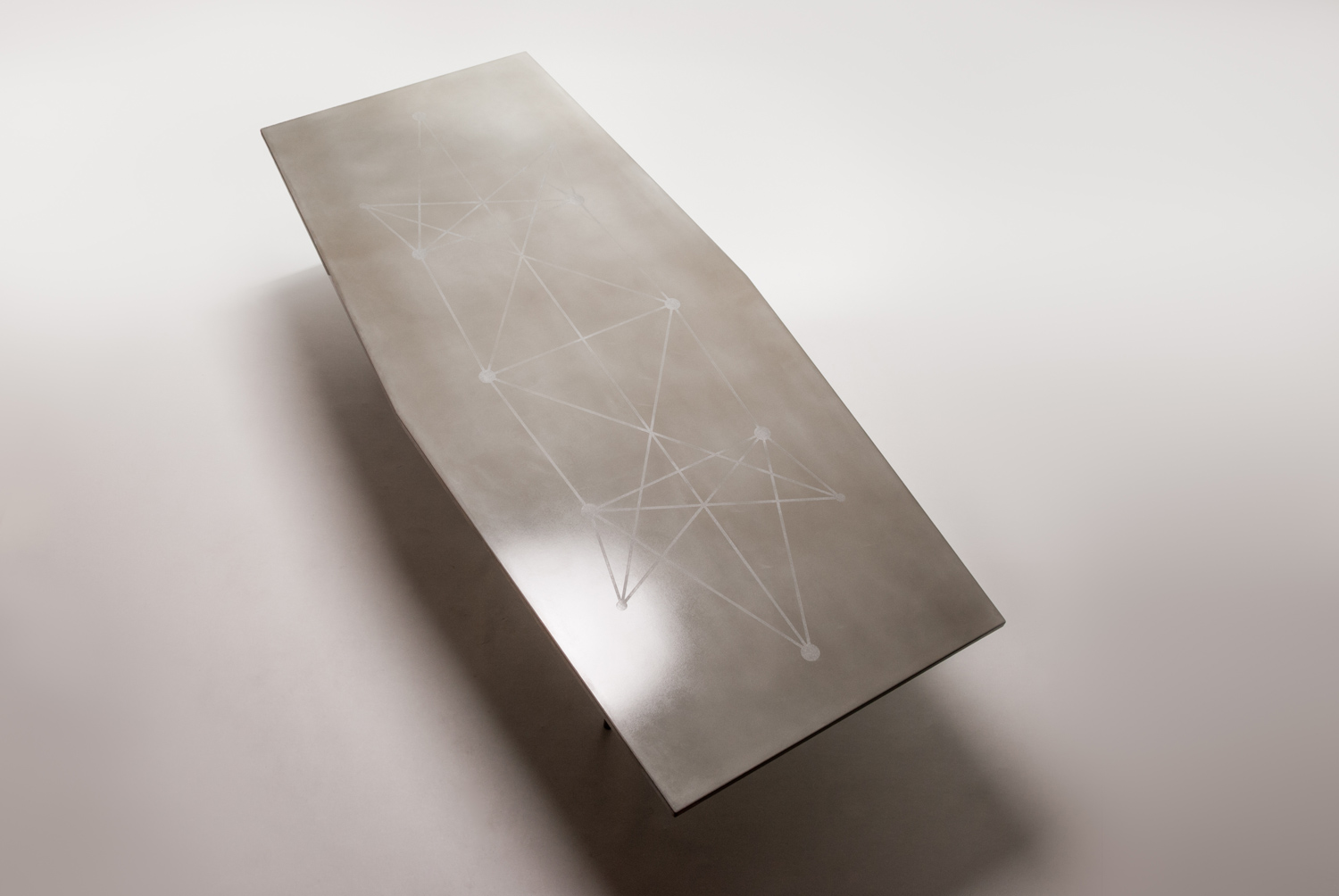 Decorative etching pattern on the surface of this custom concrete dining table