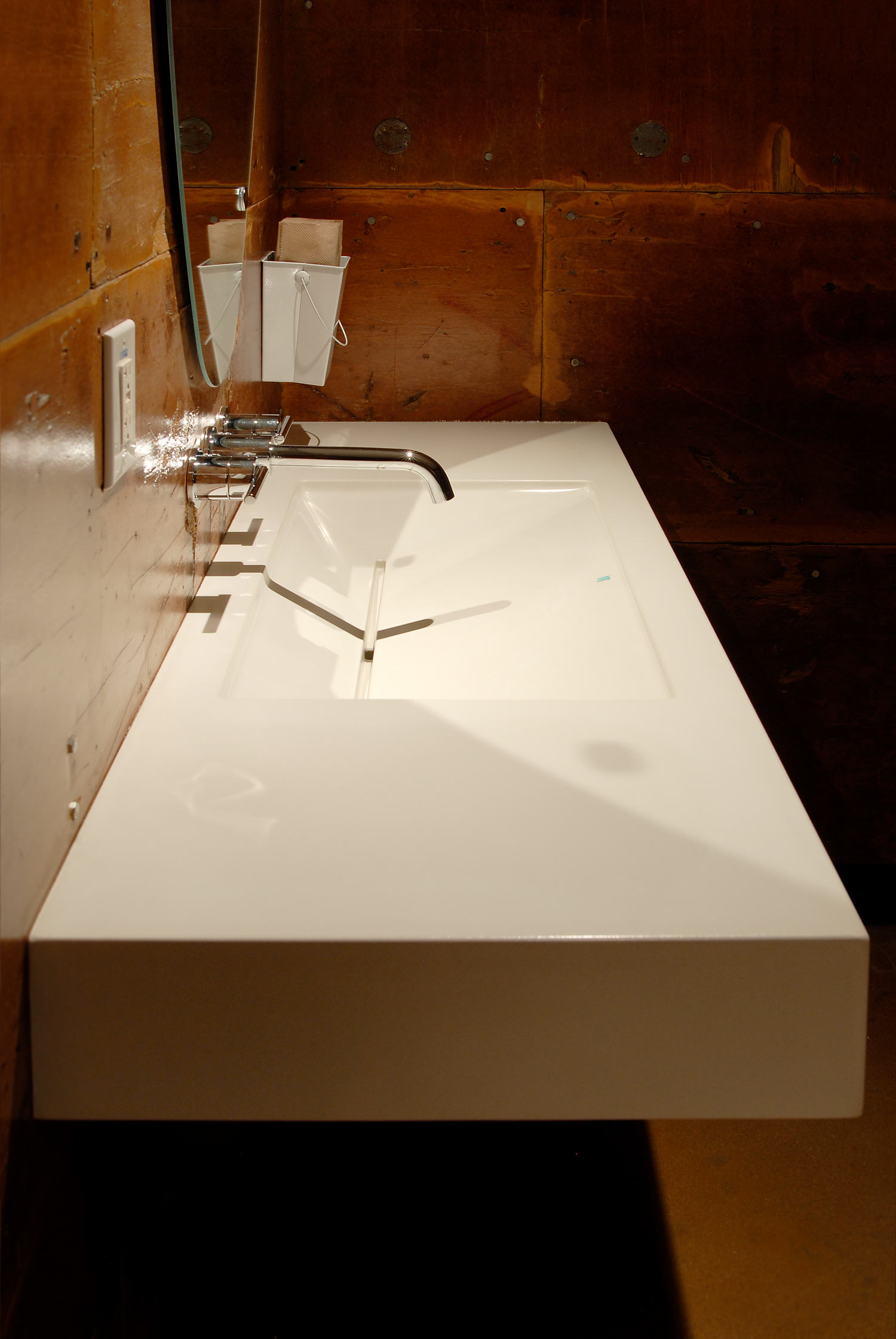 Floating white concrete ramp sink in a ADA compliant bathroom at a restaurant in downtown Phoenix, AZ. This white gfrc sink features a turquoise inlay.