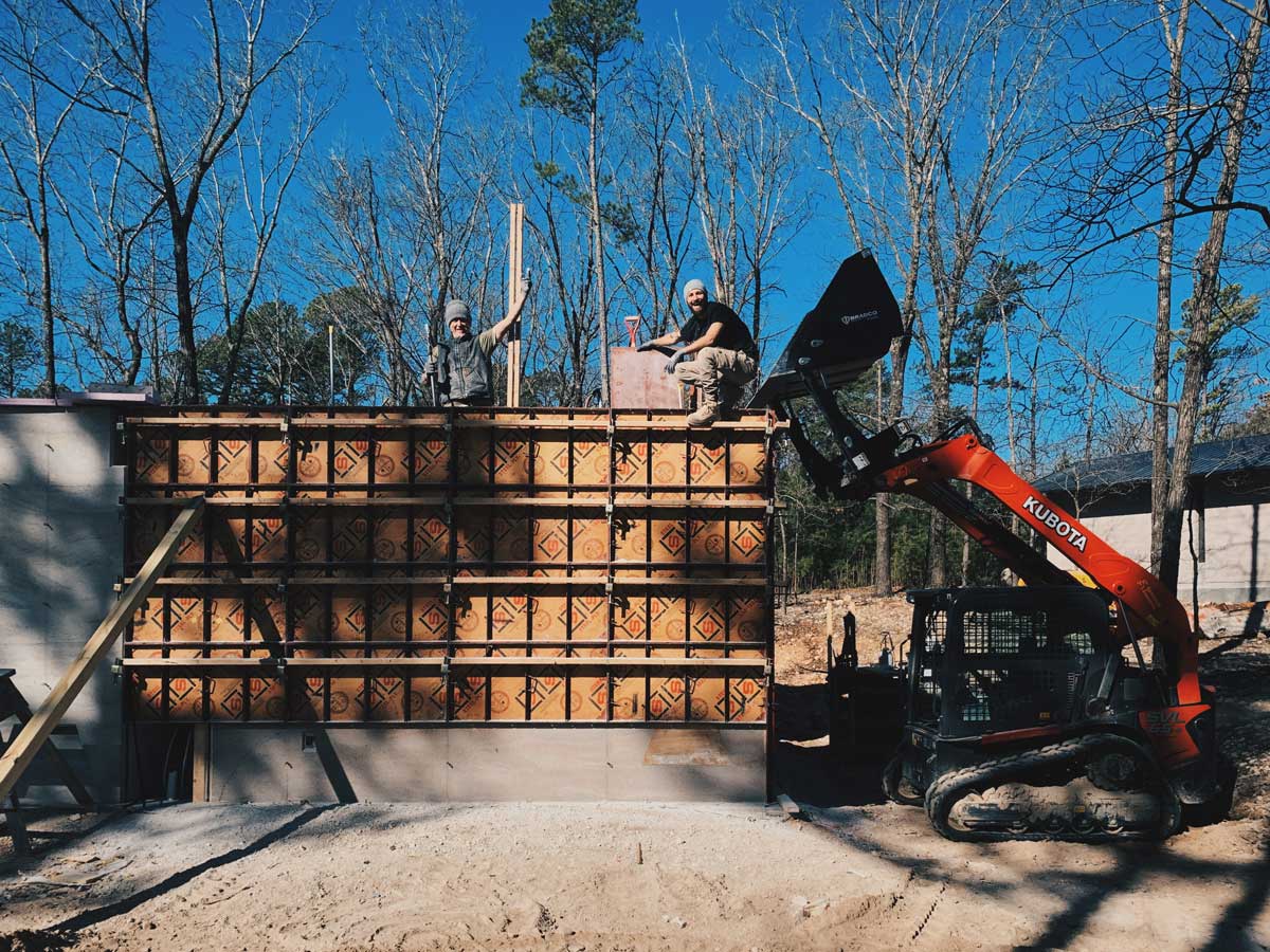 The EarthFrom crew finishing a rammed earth wall on a sustainable modern house in NW Arkansas.