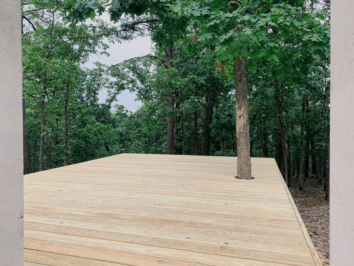 The finished modern wood deck with the oak tree growing through it.