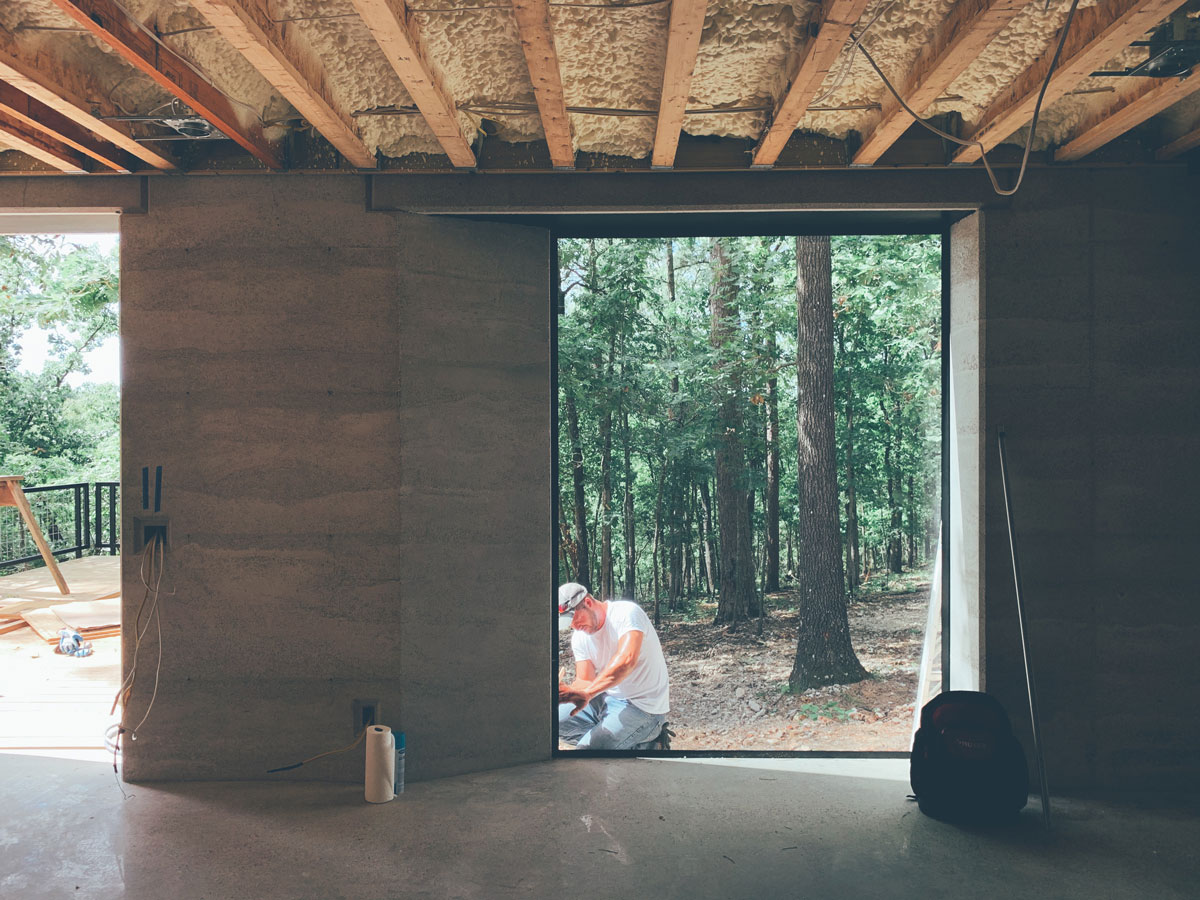 The view from inside the modern cabin in the woods into the Ozark mountain forest